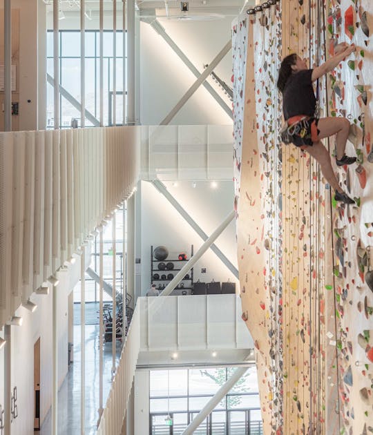 Front South woman climbing wall